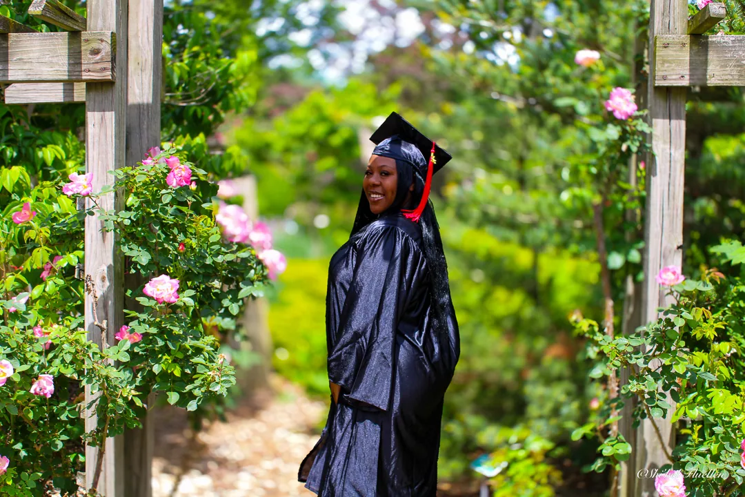 Graduate photographed in a rose garden